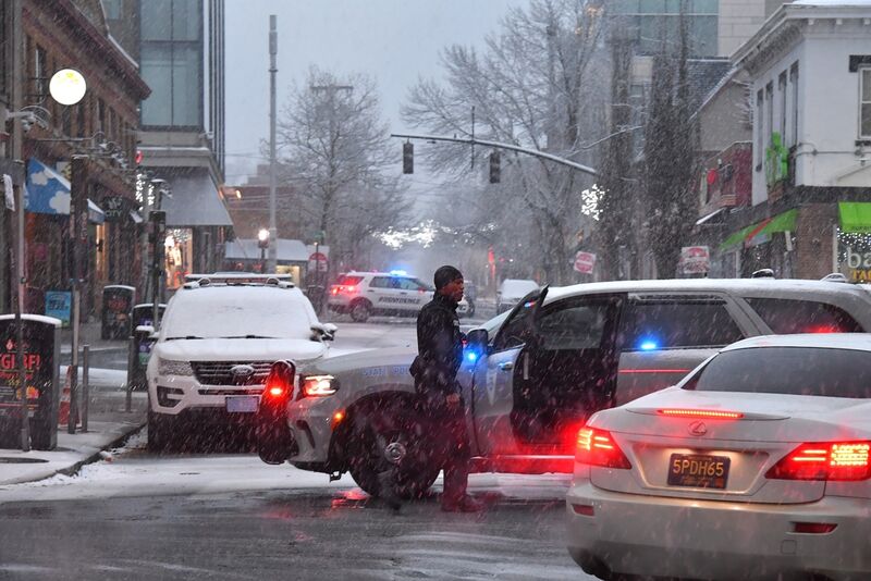 A law enforcement official directs traffic in a neighborhood near Brown University, Sunday, Dec. 14, 2025, in Providence, R.I., following a Saturday, Dec. 13 shooting at the university. (AP Photo/Steven Senne)