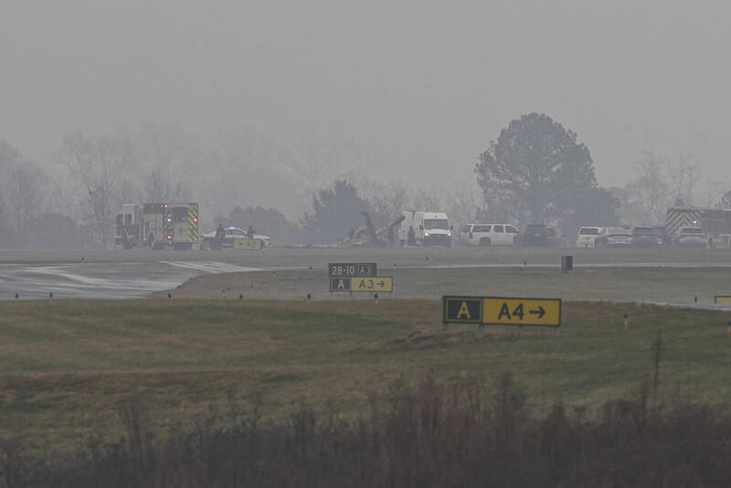 First responders tend to the scene of a reported plane crash at a regional airport in Statesville, N.C., Thursday, Dec. 18, 2025. (AP Photo/Matt Kelley)