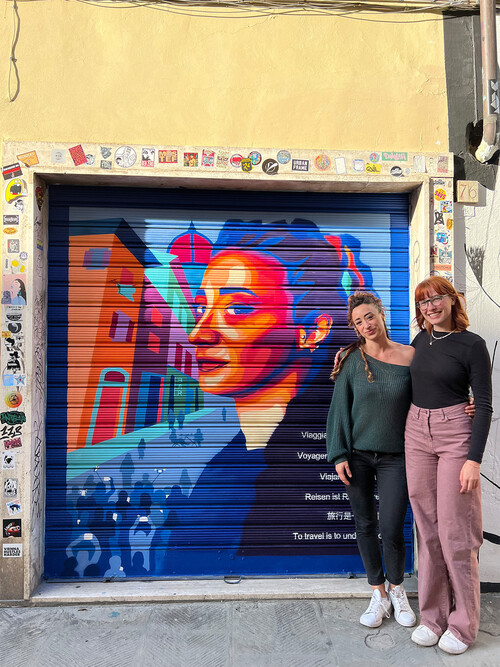 Allison Seanor (right) and her teacher Maria Antonietta at Seanor’s “To Travel is to Understand” mural in Florence, Italy. Photo by Allison Seanor.