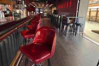 Stools line the bar at Elwood's Liquor and Tap on Thursday, July 18, 2024 in Milwaukee, Wis. This week's Republican National Convention didn't deliver an overwhelming victory to some small businesses in downtown Milwaukee. There had been earlier promises of an economic boost, but some bars, convenience stores and restaurants along the edge of the secure zone sat largely empty all week. (AP Photo/Patrick Orsagos)