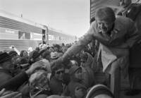 FILE - President-elect Jimmy Carter leans over to shake hands with some of the people riding the "Peanut Special" to Washington, Jan. 19, 1977. They will travel all night, arriving in Washington in time for Carter's inauguration as president on Jan. 20. (AP Photo, File)