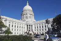 FILE - In this Oct. 10, 2012, file photo, a man walks by the Wisconsin state Capitol in Madison. (AP Photo/Scott Bauer, File)