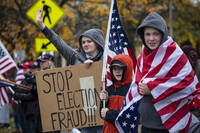 FILE - Supporters of President Donald Trump hold signs as they attend a "Stop The Steal" rally, protesting the outcome of the presidential election, at the Oregon State Capitol, Nov. 14, 2020, in Salem, Ore. (AP Photo/Paula Bronstein, File)