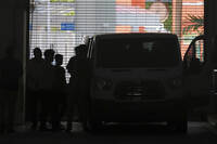 Plainclothes agents from U.S. Immigration and Customs Enforcement load people detained at the Miami Immigration Court into a Department of Homeland Security van in Miami, on Wednesday, May 21, 2025. (AP Photo/Rebecca Blackwell)