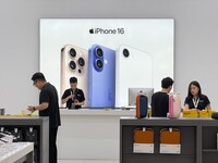 FILE - Sales staffs work at an Apple shop in Hanoi, Vietnam Thursday, April 10, 2025. (AP Photo/Hau Dinh, File)