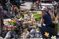 A person visits the spot of George Floyd's murder at George Floyd Square on the five-year anniversary of Floyd's death, Sunday, May 25, 2025, in Minneapolis. (AP Photo/Abbie Parr)