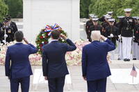 President Donald Trump, standing right, salutes at the Tomb of the Unknown Soldier, on Memorial Day at Arlington National Cemetery, in Arlington, Va., Monday, May 26, 2025. (AP Photo/Jacquelyn Martin)