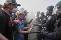 Protesters confront police on the 101 Freeway near the Metropolitan Detention Center of downtown Los Angeles, Sunday, June 8, 2025, following last night's immigration raid protest. (AP Photo/Jae C. Hong)