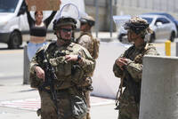 Members of the California National Guard and U.S. Marines guard a federal building on Tuesday, June 17, 2025, in Los Angeles. (AP Photo/Damian Dovarganes)