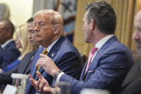 President Donald Trump, left, listens as Secretary of Defense Pete Hegseth, right, speaks during a cabinet meeting at the White House, Tuesday, July 8, 2025, in Washington. (AP Photo/Evan Vucci)