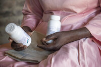 FILE - Florence Makumene holds HIV medication that she received through funding from the U.S. President's Emergency Plan for AIDS Relief (PEPFAR), along with her hospital records book, at her home in Harare, Zimbabwe, Feb. 7, 2025. (AP Photo/Aaron Ufumeli, File)