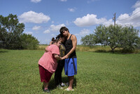 Juanita is hugged by her children, Jose, 15, and daughter Marely, 17, who has Down syndrome, Tuesday, June 17, 2025, during a portrait in Hidalgo County, Texas. (AP Photo/Jacquelyn Martin)