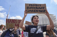 FILE - Hannah Liu, 26, of Washington, holds up a sign in support of birthright citizenship, May 15, 2025, outside of the Supreme Court in Washington. "This is enshrined in the Constitution. My parents are Chinese immigrants," says Liu. "They came here on temporary visas so I derive my citizenship through birthright." (AP Photo/Jacquelyn Martin, File)