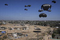 Palestinians rush to collect humanitarian aid airdropped into Zawaida in central Gaza Strip, Thursday, July 31, 2025. (AP Photo/Abdel Kareem Hana)