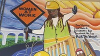 FILE - A mural by artist Tene Smith is seen near the entrance of Chicago Women in Trades, a nonprofit dedicated to training and retaining women in the skilled construction trades is photographed April 1, 2025, at the facility in Chicago. (AP Photo/Claire Savage, File)
