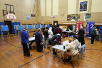 FILE - Voters wait to receive their ballots at a polling place at McDonald Elementary School, Nov. 5, 2024, in Dearborn, Mich. (AP Photo/Charlie Neibergall, File)