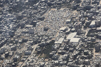 A tent camp in Gaza City is seen from a Jordanian Air Force C-130 plane during an airdrop of humanitarian aid for Palestinians on the Gaza Strip, Thursday, Aug. 7, 2025. (AP Photo/Raad Adayleh)