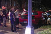 Agents from various agencies including Bureau of Alcohol, Tobacco, Firearms and Explosives, Park Police, and FBI, question a couple who had been parked in a car with Washington D.C. plates outside of a legal parking spot while eating McDonald's takeout, Tuesday, Aug. 12, 2025, in northwest Washington near Kennedy St. NW. The couple were released after a search of the car. (AP Photo/Jacquelyn Martin)