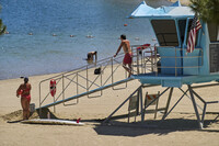 Los Angeles County lifeguards stand on guard as people cool off at Castaic Lake on Wednesday, Aug. 20, 2025, in Castaic, Calif. (AP Photo/Damian Dovarganes)