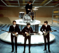 FILE -The Beatles, foreground from left, Paul McCartney, George Harrison, John Lennon and Ringo Starr, on drums, perform on the CBS "Ed Sullivan Show" in New York, Feb. 9, 1964. (AP Photo/File)