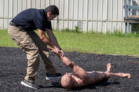 An Immigration and Customs Enforcement (ICE) instructor demonstrates getting a 170 lb. dummy into a position to be handcuffed on the agility course at the Federal Law Enforcement Training Centers (FLETC) in Brunswick, Ga. on Thursday, Aug. 21, 2025. (AP Photo/Fran Ruchalski)