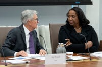 FILE - Federal Reserve Chairman Jerome Powell, left, talks with Board of Governors member Lisa Cook, right, during an open meeting of the Board of Governors at the Federal Reserve, June 25, 2025, in Washington. (AP Photo/Mark Schiefelbein, File)