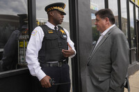 Chicago Police Cmdr, Herbert Williams, left, speaks with Illinois Gov. J.B. Pritzker Wednesday, Aug. 27, 2025, in the Bronzeville neighborhood of Chicago. (AP Photo/Erin Hooley)