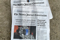 Printed copies of The Atlanta Journal-Constitution are shown on Thursday, Aug. 28, 2025, in Atlanta. (AP Photo/Jeff Amy)