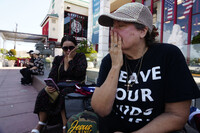 Cecilia Garcia and Dawn Thomas react as they learn the news on social media of Charlie Kirk, a conservative activist being shot at a college event in Utah, in Westminster, Calif., on Wednesday, Sept. 10, 2025. (AP Photo/Damian Dovarganes)