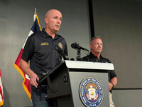 Utah Gov. Spencer Cox, left, speaks with Utah Valley University Chief of Police Jeff Long, right, at a press conference at the Keller Building on the Utah Valley University campus after Charlie Kirk was shot and died during Turning Point's visit to the university, Wednesday, Sept. 10, 2025, in Orem, Utah. (AP Photo/Hannah Schoenbaum)