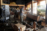 FILE - An employee surveys the damage at the Great Outdoor Provision Co. after it was flooded during tropical storm Chantal, Monday, July 7, 28, 2025, in Chapel Hill, N.C. (AP Photo/Chris Seward, file)