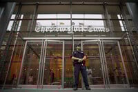 FILE- A police officer stands guard outside The New York Times building in New York, on June 28, 2018. (AP Photo/Mary Altaffer, File)