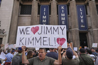 Oscar Villanueva holds a sign outside El Capitan Entertainment Centre, where the late-night show "Jimmy Kimmel Live!" is staged, Thursday, Sept. 18, 2025, in Los Angeles. (AP Photo/Jae C. Hong)
