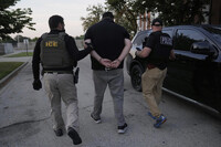 U.S. Immigration and Customs Enforcement agents make an arrest during an early morning operation in Park Ridge, Ill., Friday, Sept. 19, 2025. (AP Photo/Erin Hooley)
