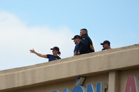 Law enforcement agents look around the roof of an apartment building near the scene of a shooting at a U.S. Immigration and Customs Enforcement office in Dallas on Wednesday, Sept. 24, 2025. (AP Photo/Julio Cortez)