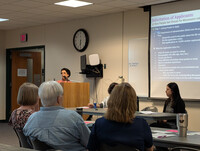 Photo of speaker at presentation
