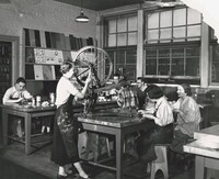 Students restore and refinish an 1855 antique wooden spinning wheel. Photo circa 1953.