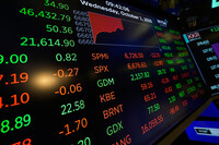 Financial information is displayed as traders work on the floor at the New York Stock Exchange in New York, Wednesday, Oct. 1, 2025. (AP Photo/Seth Wenig)