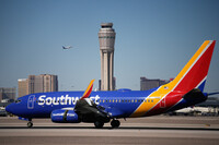 Planes land and take off at Harry Reid International Airport, Tuesday, Oct. 7, 2025, in Las Vegas. (AP Photo/John Locher)