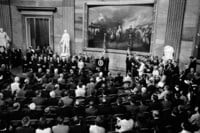 FILE - President Lyndon Johnson, at podium, speaks in the rotunda of the Capitol in Washington, before to signing the Voting Rights Act, Aug. 6, 1965. (AP Photo, File)