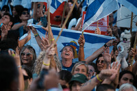 People react as they gather to watch a live broadcast of Israeli hostages released from Gaza at a plaza known as hostages square in Tel Aviv, Israel, Monday, Oct. 13, 2025. (AP Photo/Emilio Morenatti)
