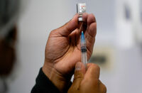 FILE - A healthcare worker prepares a shot of the Pfizer COVID-19 vaccine in La Paz, Bolivia, Jan. 7, 2025. (AP Photo/Juan Karita, File)