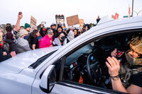 Protesters block a caravan of U.S. Border Patrol personnel from entering Coast Guard Base Alameda on Thursday, Oct. 23, 2025, in Oakland, Calif. (AP Photo/Noah Berger)