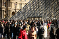 Visitors queue outside the Louvre museum, one week after the robbery, Sunday, Oct. 26, 2025 in Paris. The Paris prosecutor said on Sunday that a number of suspects have been arrested over the theft of crown jewels from Paris' Louvre museum last weekend. (AP Photo/Thomas Padilla)