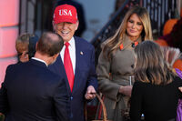 President Donald Trump, center left, and first lady Melania Trump, center right, greet families and hand out candy during a Halloween event on the South Lawn of the White House, Thursday, Oct. 30, 2025, in Washington. (AP Photo/Jacquelyn Martin)