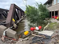 The aftermath of heavy rainfall near the Menomonee River in the village area in Wauwatosa is seen here on Monday, Aug. 11, 2025. Evan Casey/WPR
