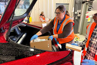 Employees at The Food Bank Inc. load food into a car on Thursday, Oct. 30, 2025 in Dayton, Ohio. (AP Photo/Patrick Aftoora-Orsagos)