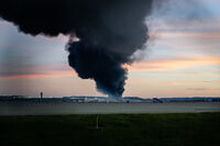 A plume of smoke rises from the site of a UPS cargo plane crash at Louisville Muhammad Ali International Airport on Tuesday, Nov. 4, 2025, in Louisville, Ky. (AP Photo/Jon Cherry)