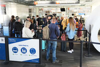 Travelers stand in line in a TSA screening area at Philadelphia International Airport in Philadelphia, Wednesday, Nov. 5, 2025. (AP Photo/Matt Rourke)