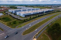 FILE - Cars drive past data centers that house computer servers and hardware required to support modern internet use, such as artificial intelligence, in Ashburn, Virginia, July 16, 2023. (AP Photo/Ted Shaffrey, File)